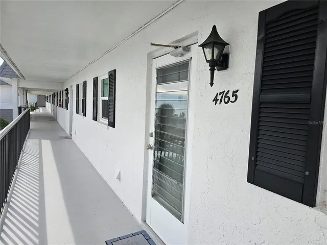 a view of a hallway with a white walls
