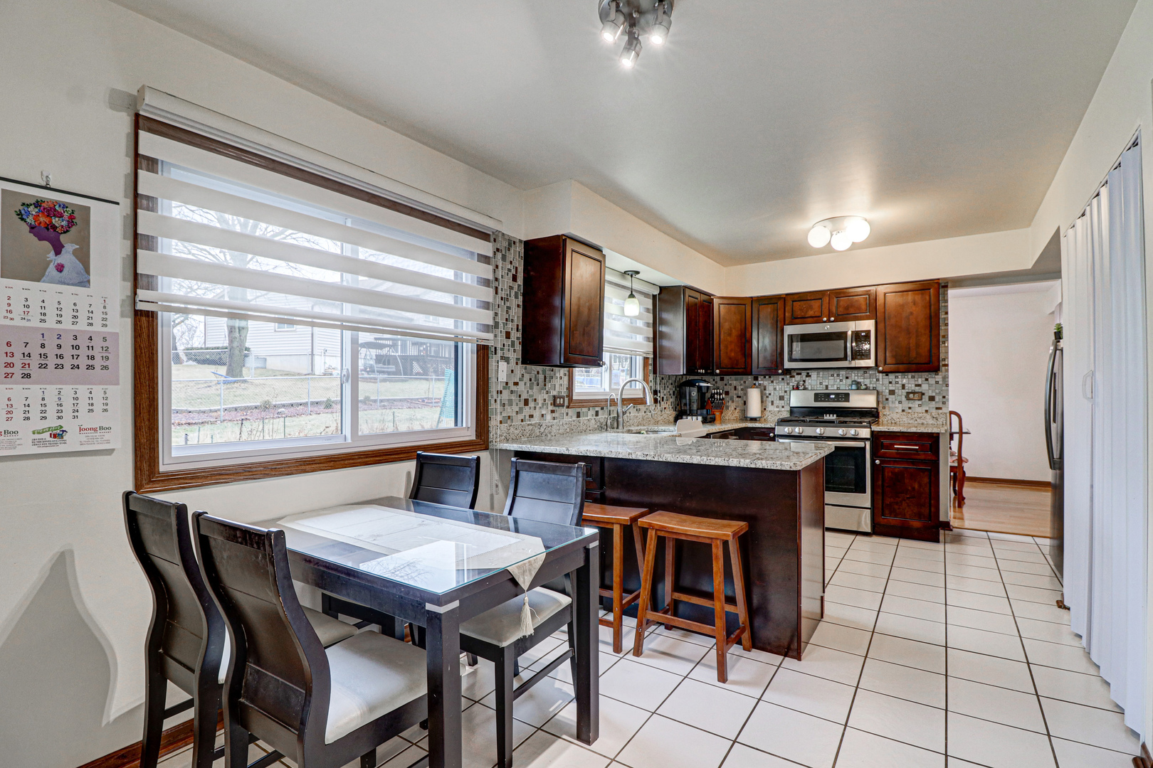 1126 Manchester Road Schaumburg, IL 60193 - Photo 11 of 28 a kitchen with a table and chairs in it