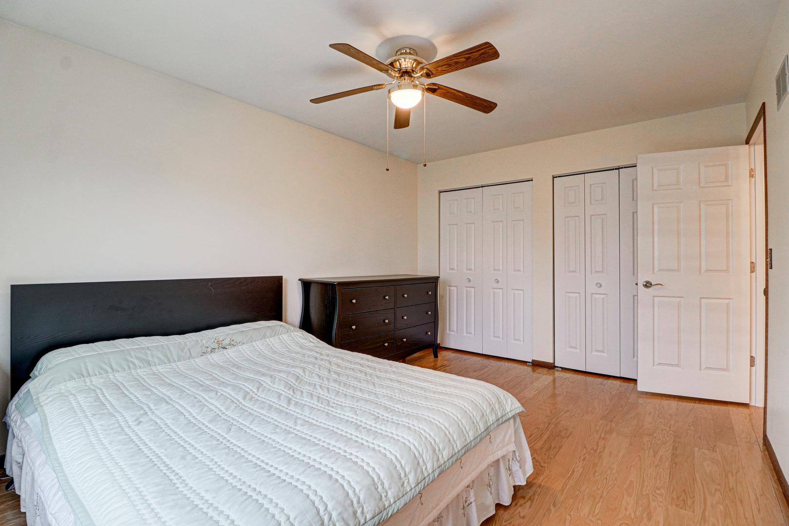 1126 Manchester Road Schaumburg, IL 60193 - Photo 20 of 28 a bedroom with a bed and a ceiling fan