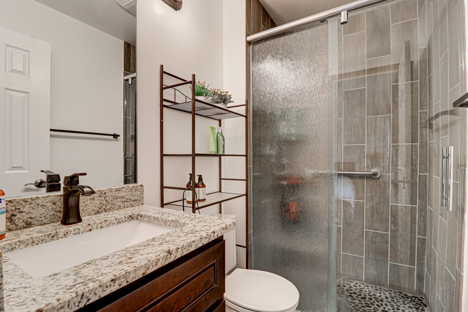 1126 Manchester Road Schaumburg, IL 60193 - Photo 21 of 28 a bathroom with a granite countertop sink toilet and shower