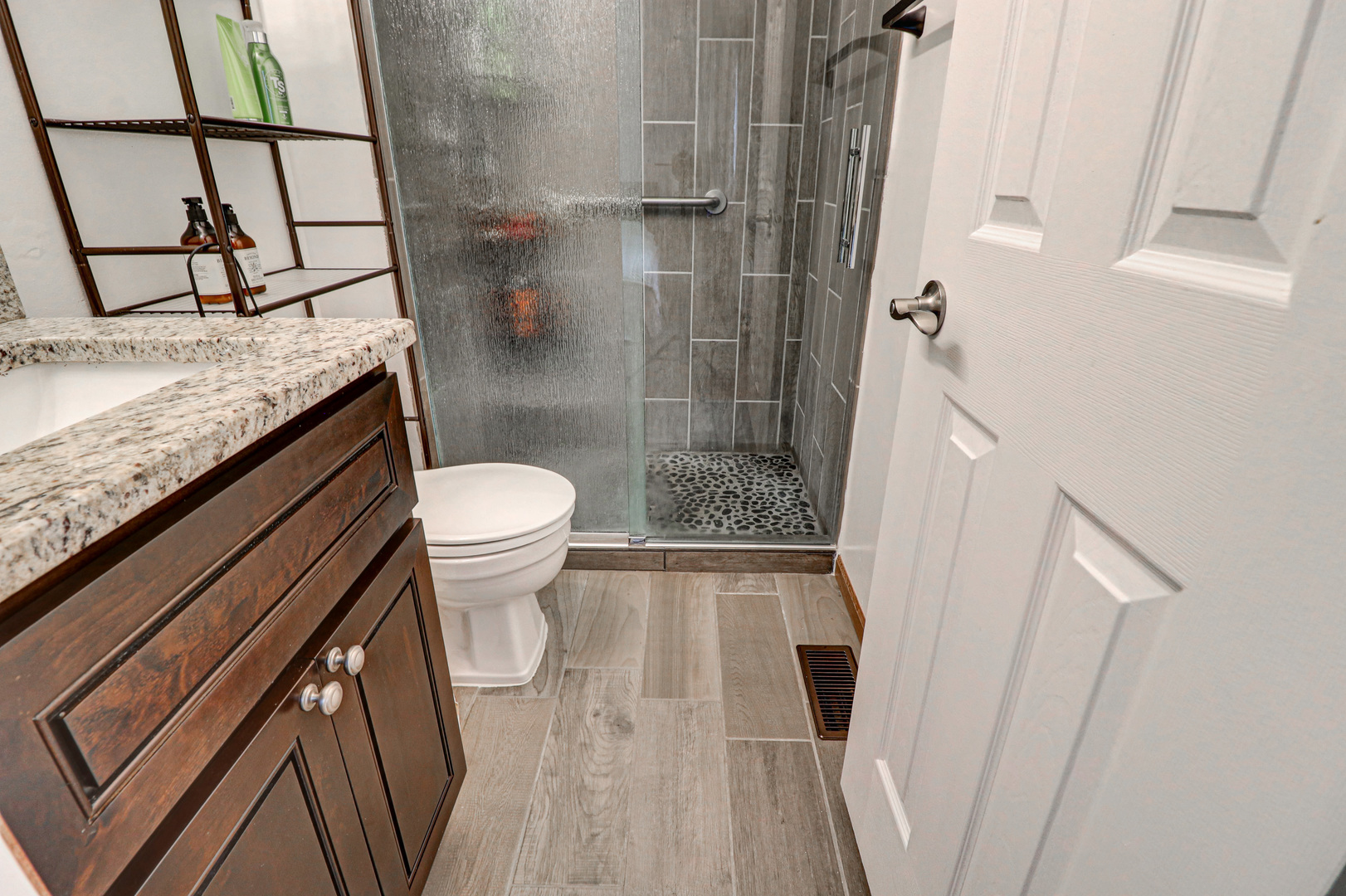 1126 Manchester Road Schaumburg, IL 60193 - Photo 22 of 28 a bathroom with a granite countertop sink toilet and shower