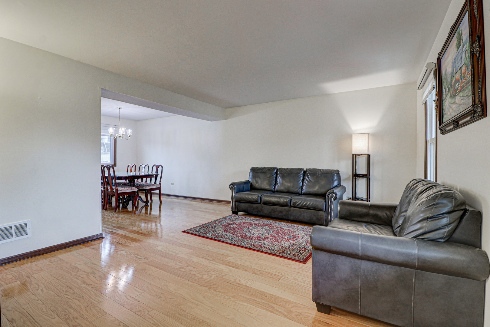 1126 Manchester Road Schaumburg, IL 60193 - Photo 4 of 28 a living room with furniture and a dining table with kitchen view