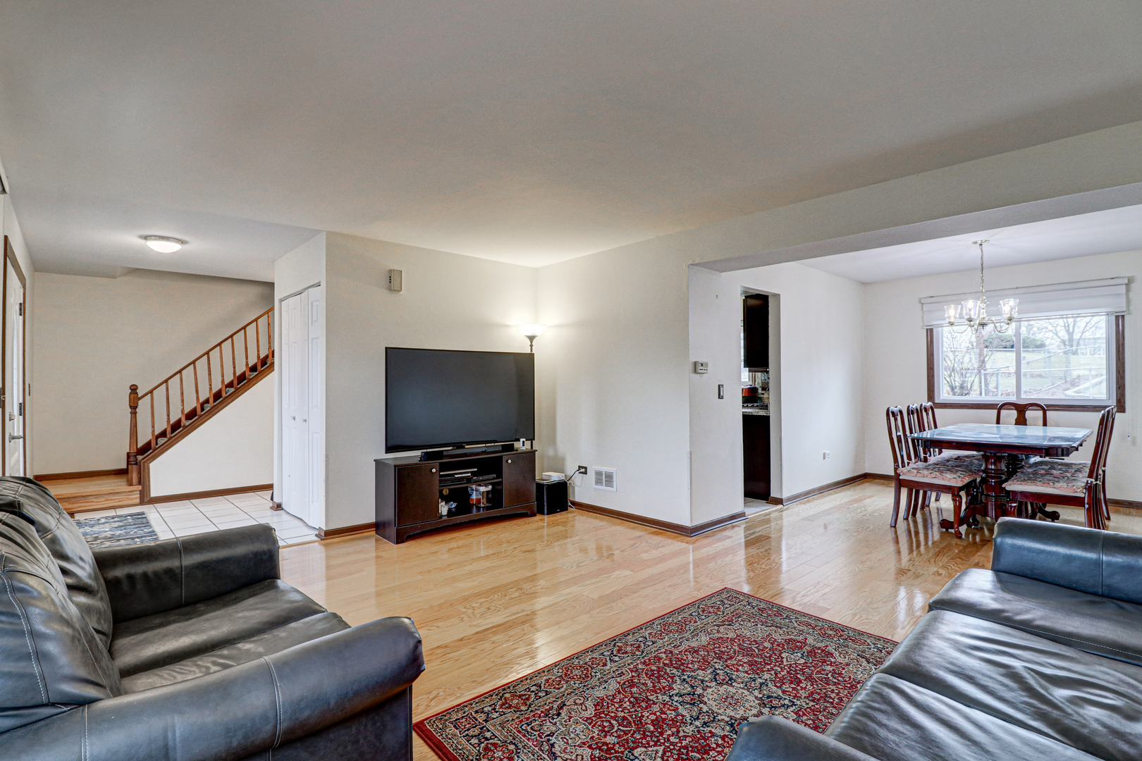 1126 Manchester Road Schaumburg, IL 60193 - Photo 5 of 28 a living room with furniture and a flat screen tv