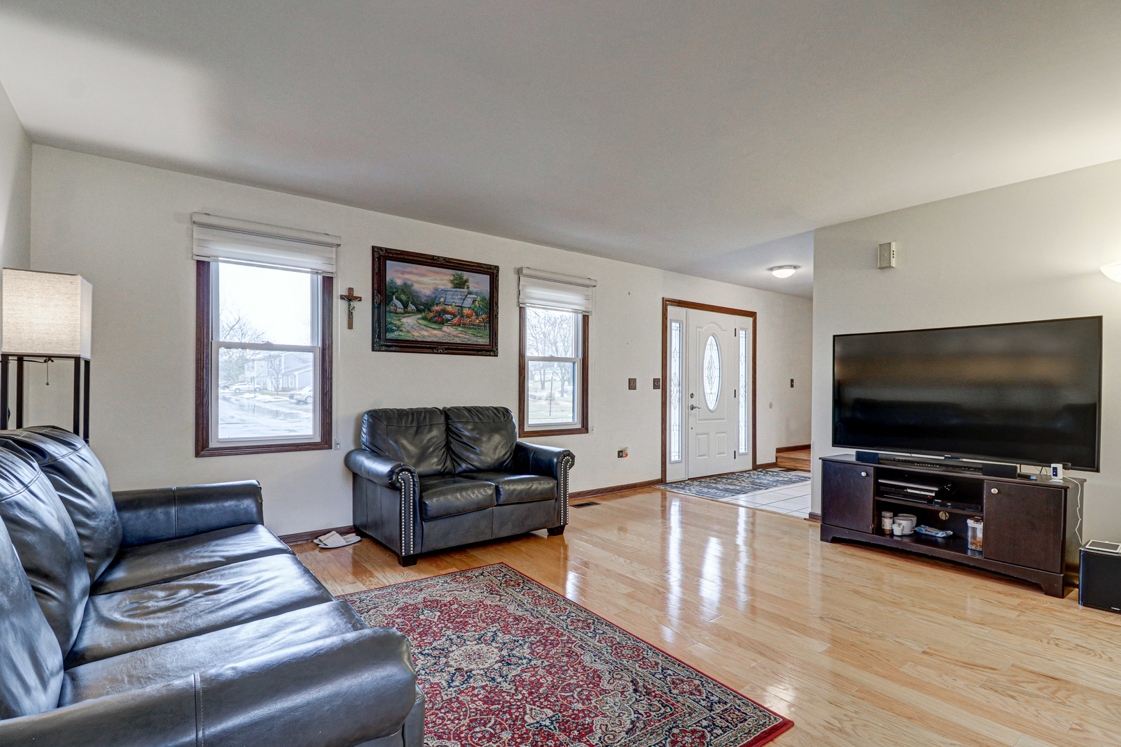 1126 Manchester Road Schaumburg, IL 60193 - Photo 6 of 28 a living room with furniture and a flat screen tv