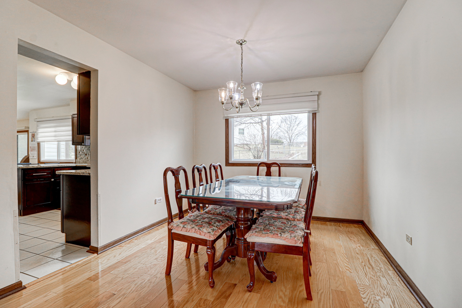 1126 Manchester Road Schaumburg, IL 60193 - Photo 7 of 28 a view of a dining room with furniture window and wooden floor