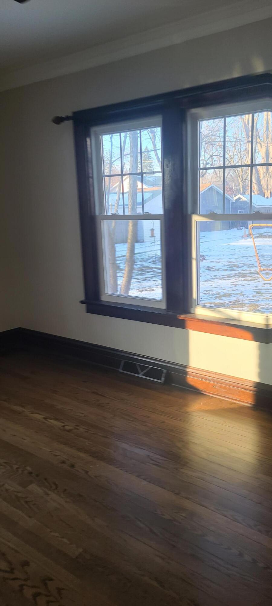 669 South 2nd Street Chesterton, IN 46304 - Photo 11 of 42 an empty room with wooden floor and windows