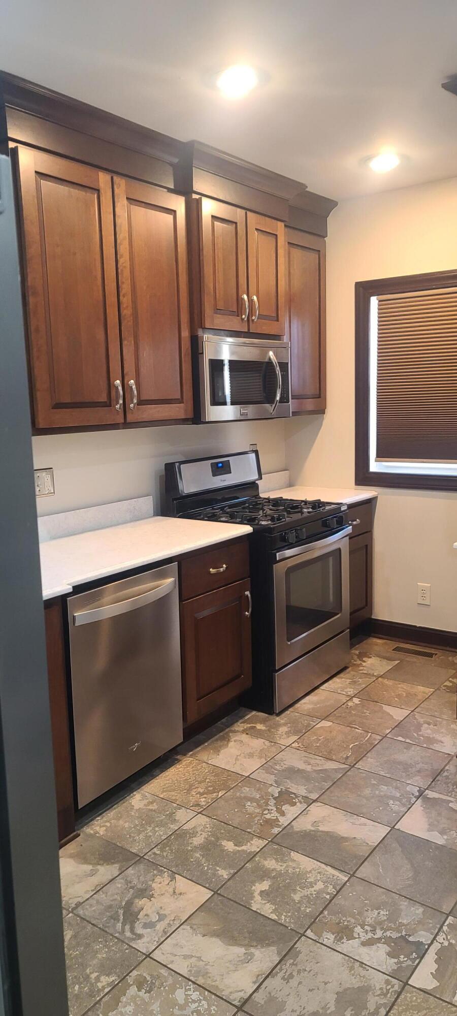 669 South 2nd Street Chesterton, IN 46304 - Photo 19 of 42 a kitchen with stainless steel appliances granite countertop a stove a sink and a microwave