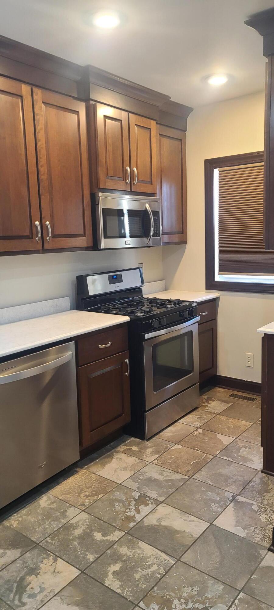 669 South 2nd Street Chesterton, IN 46304 - Photo 24 of 42 a kitchen with stainless steel appliances granite countertop a stove a sink and a microwave