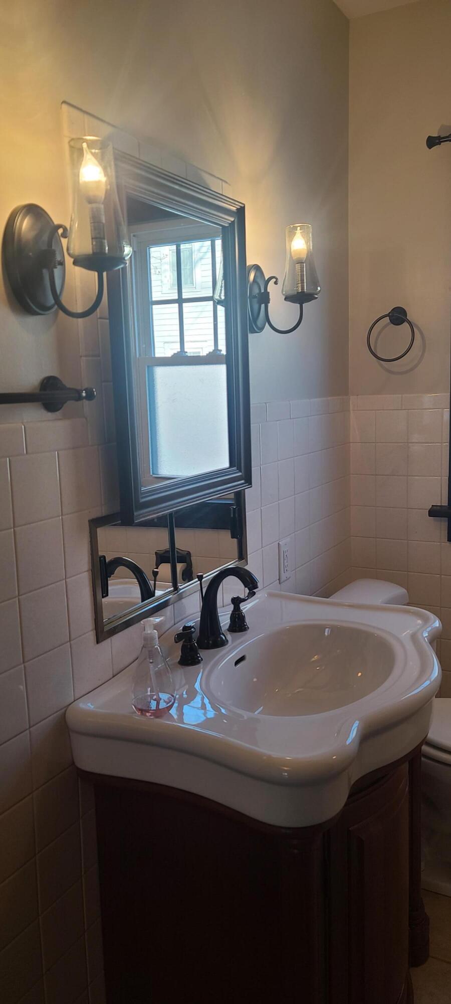 669 South 2nd Street Chesterton, IN 46304 - Photo 30 of 42 a bathroom with a sink and a mirror