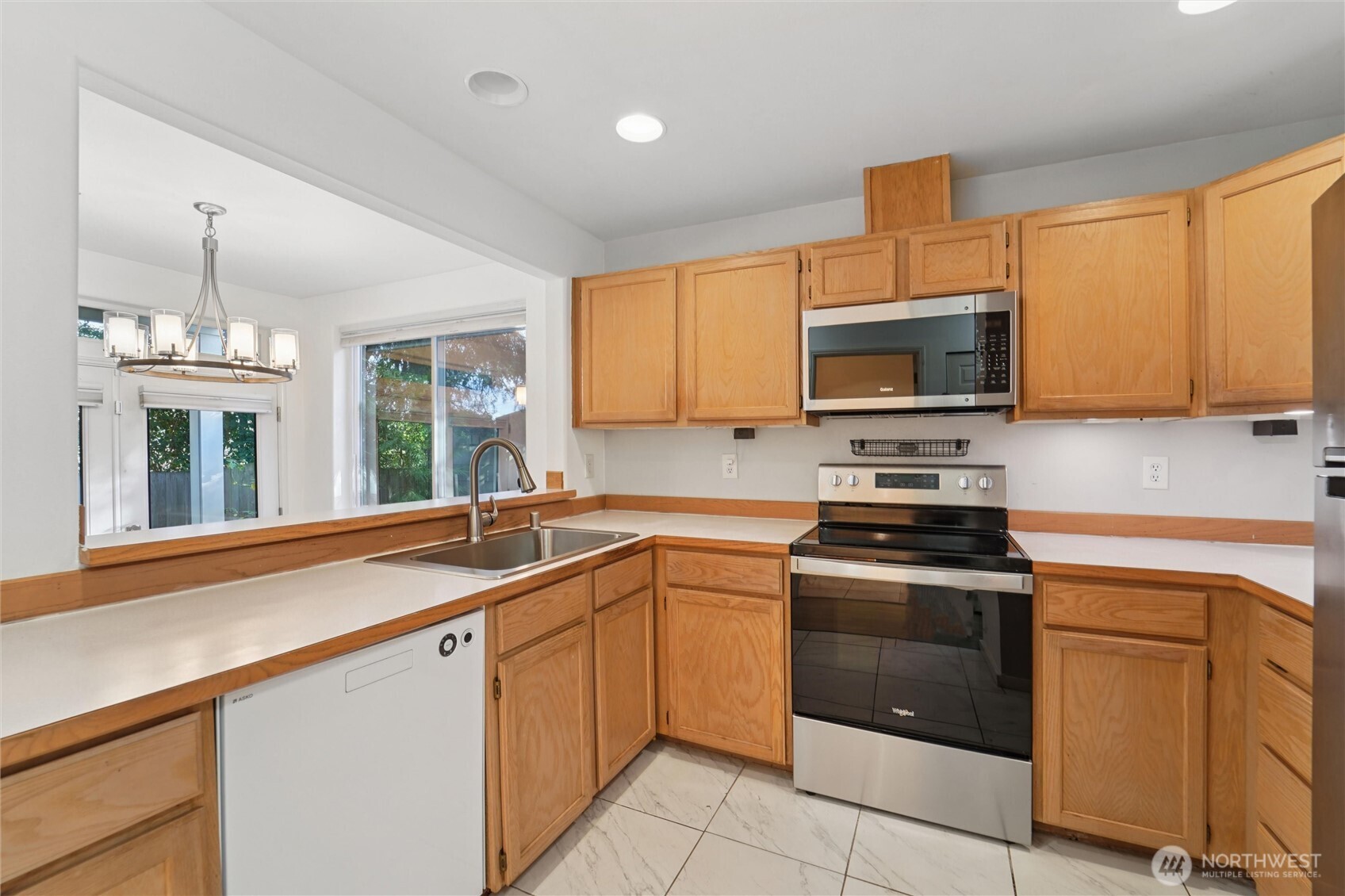 8515 244th Street Southwest, Unit A5 Edmonds, WA 98026 - Photo 11 of 20 a kitchen with granite countertop a sink stainless steel appliances and cabinets