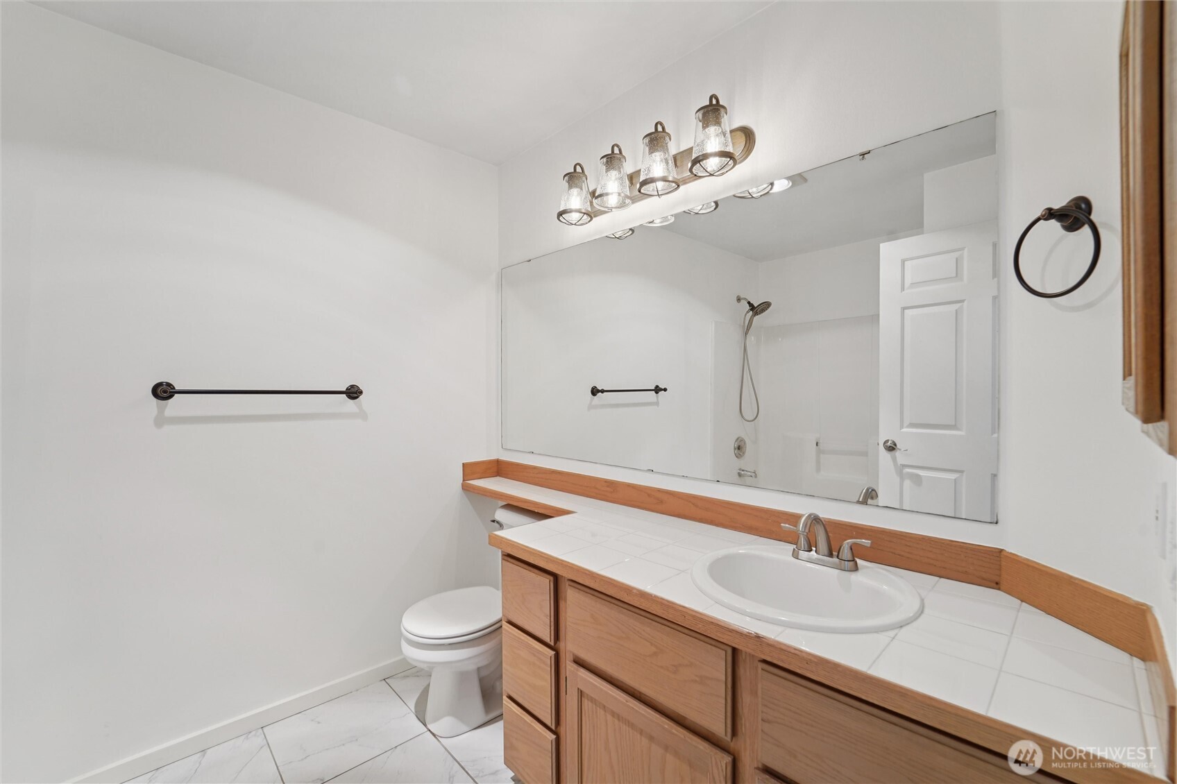 8515 244th Street Southwest, Unit A5 Edmonds, WA 98026 - Photo 12 of 20 a bathroom with a sink a toilet and a mirror