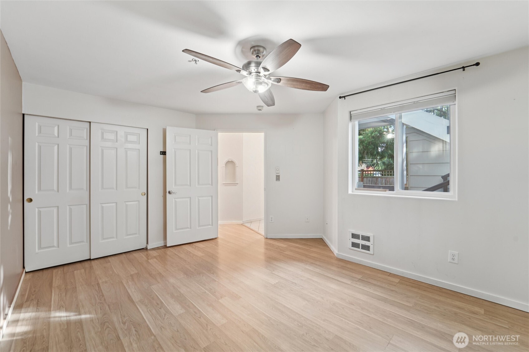 8515 244th Street Southwest, Unit A5 Edmonds, WA 98026 - Photo 13 of 20 a view of an empty room with wooden floor and a window