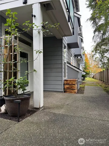 a view of a house with a yard and potted plants