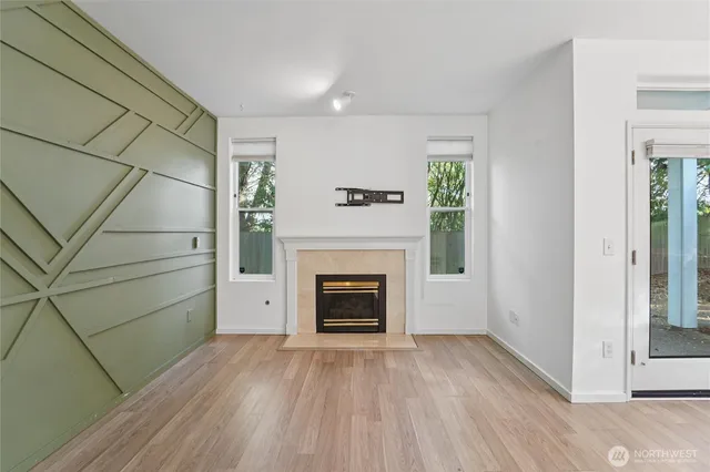 a view of a livingroom with a fireplace and window