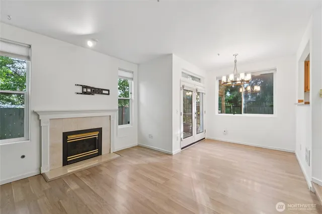 a view of an empty room with window and fireplace