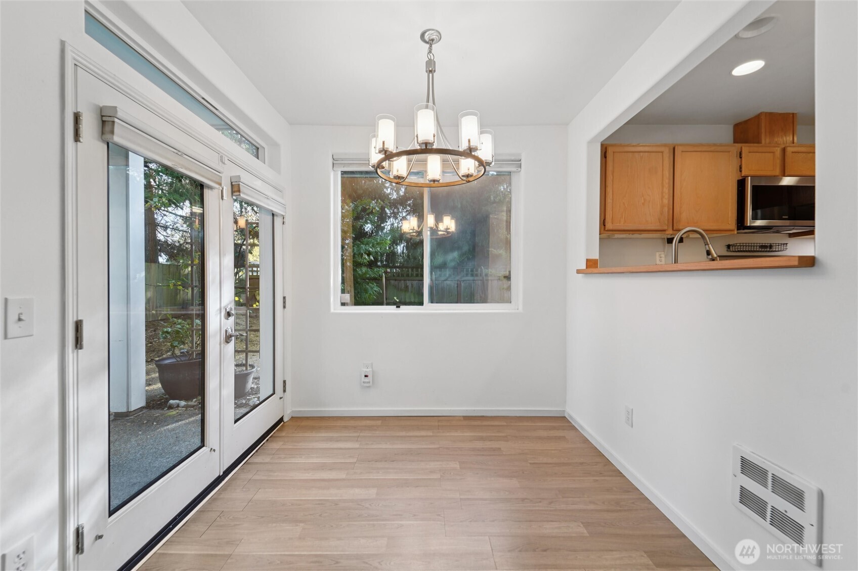8515 244th Street Southwest, Unit A5 Edmonds, WA 98026 - Photo 8 of 20 a view of a hallway with wooden floor and chandelier
