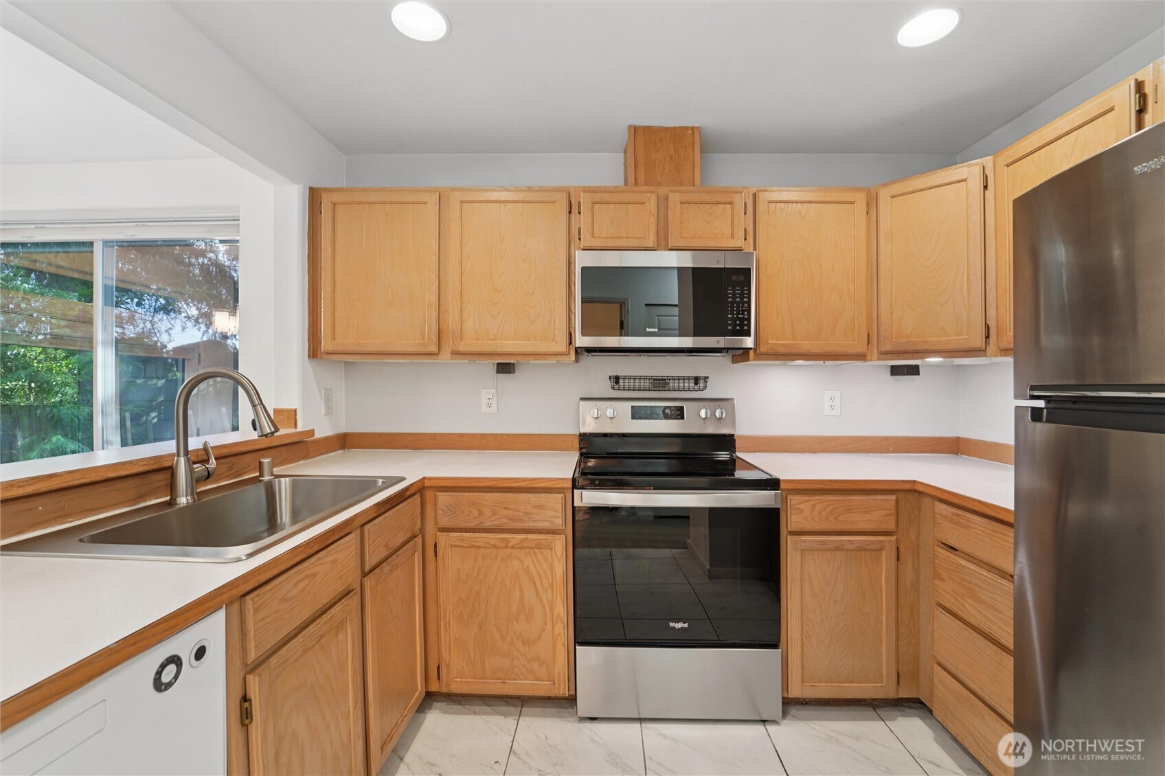 8515 244th Street Southwest, Unit A5 Edmonds, WA 98026 - Photo 9 of 20 a kitchen with a sink stove and microwave