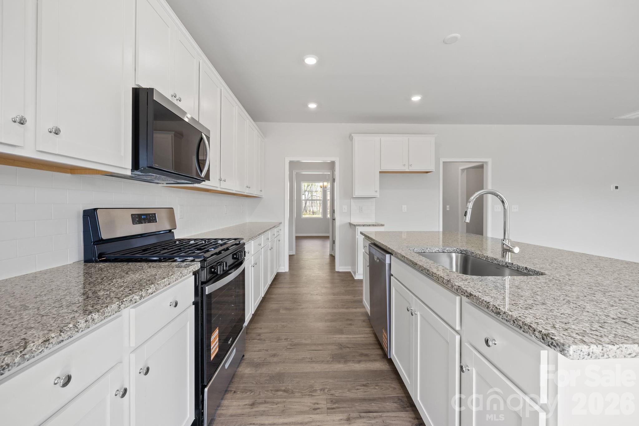 426 Brick House Road York, SC 29745 - Photo 13 of 35 a kitchen with stainless steel appliances granite countertop a sink and stove top oven