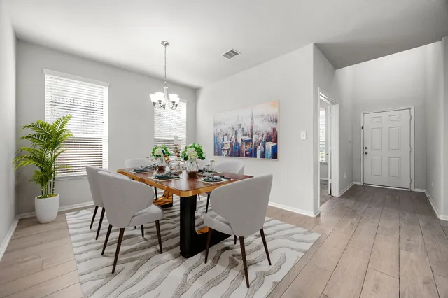 a view of a dining room with furniture window and wooden floor