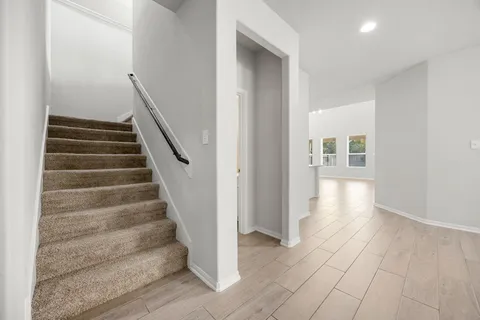 a view of an entryway with wooden floor and stairs