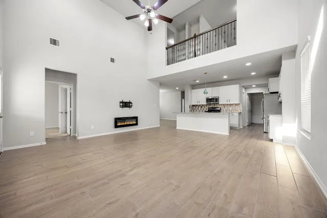 a view of a kitchen with a sink and a refrigerator