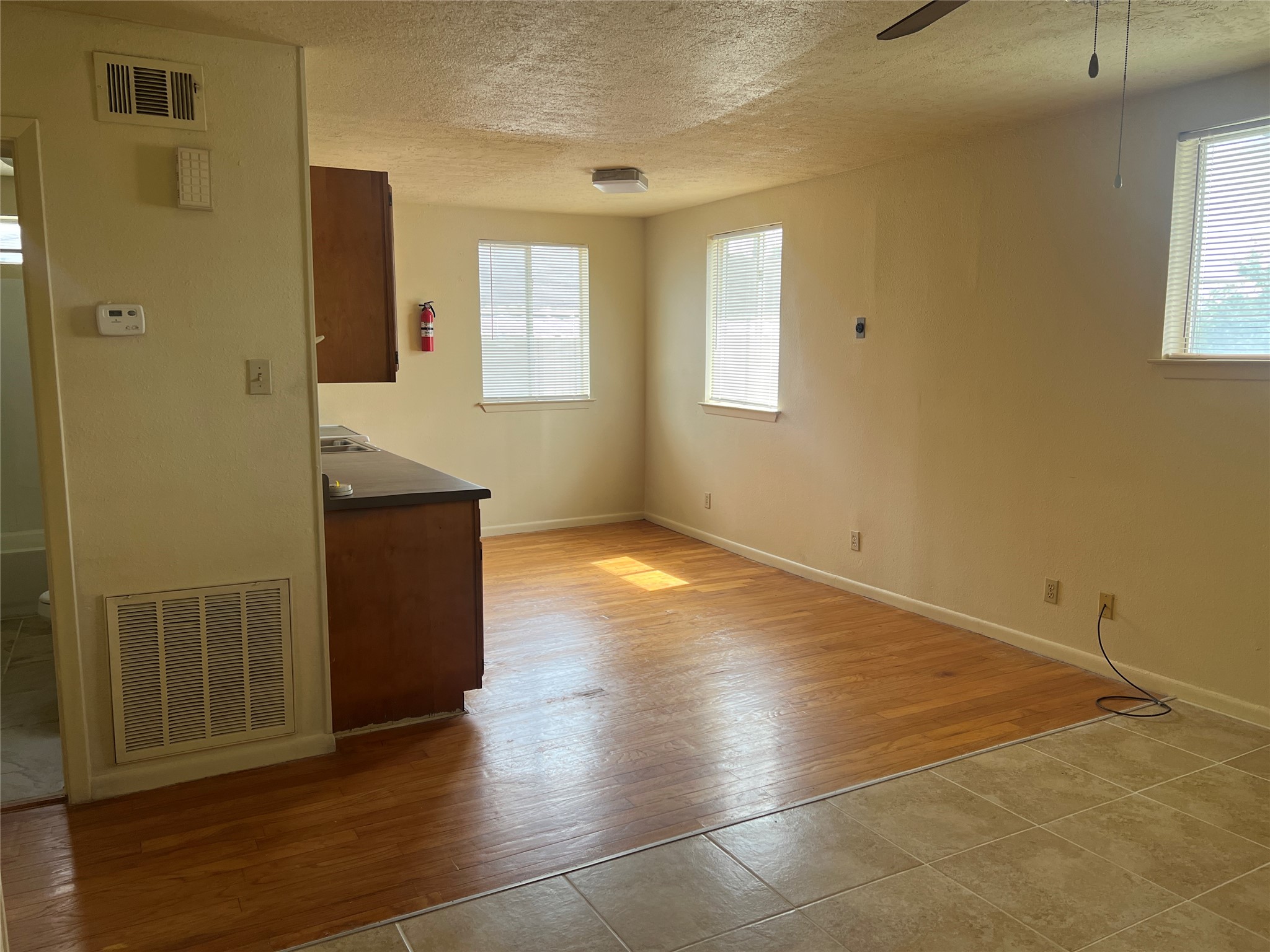 1201 Gillette Street, Unit 4 Houston, TX 77019 - Photo 7 of 12 an empty room with wooden floor and windows