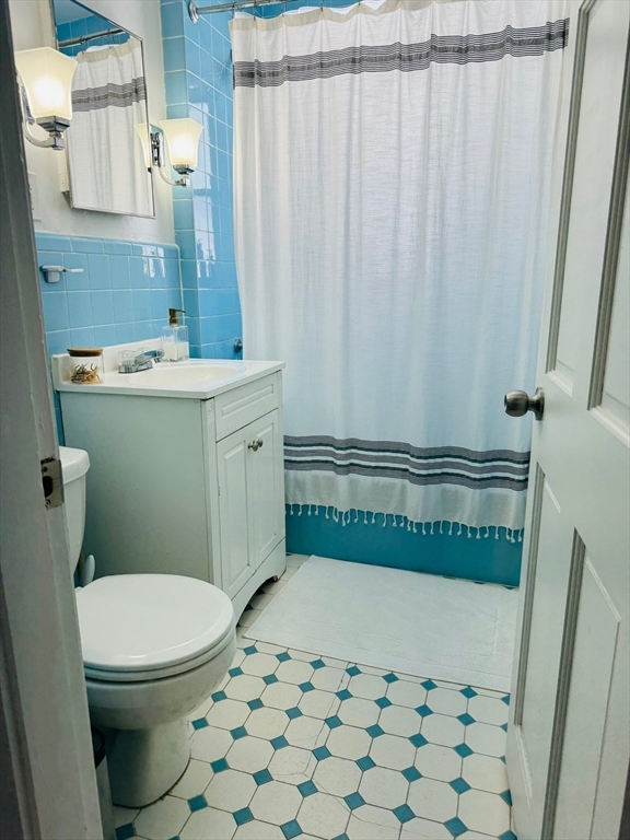 43 Chapman Street, Unit 2 Watertown, MA 02472 - Photo 7 of 12 a bathroom with a toilet a sink and a shower