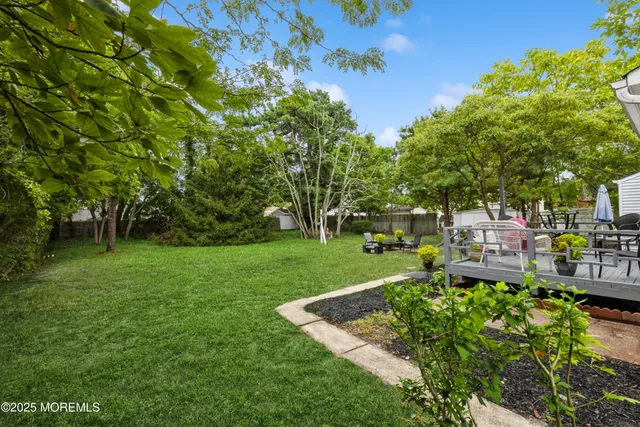 a view of yard with swimming pool and green space