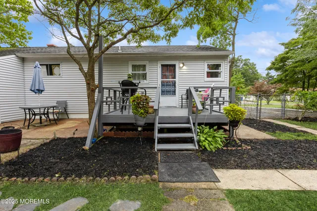 a view of a house with a yard and sitting area