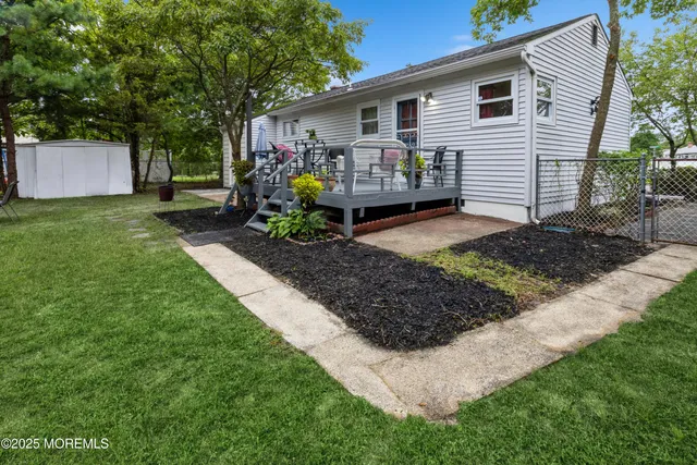 a front view of house with a garden and patio