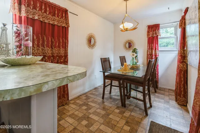 a dining room with a table and chairs