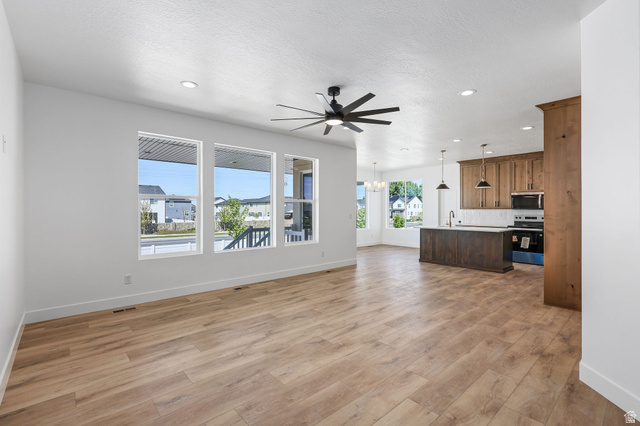 1144 South 4475 West West Point, UT 84015 - Photo 4 of 30 Open concept living space featuring wood-finish flooring, recessed lighting, and a dark-bladed ceiling fan