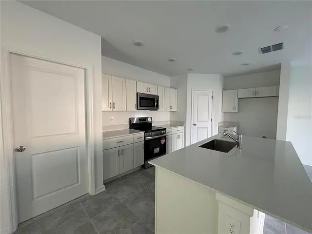 a kitchen with a sink a stove and refrigerator