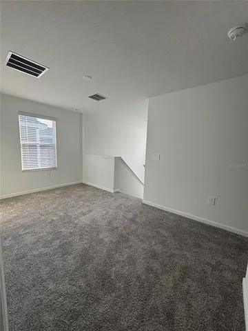 an empty room with a empty space and windows