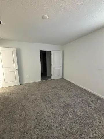 a view of an empty room and entryway