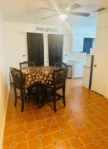 a view of a dining room with furniture and a rug