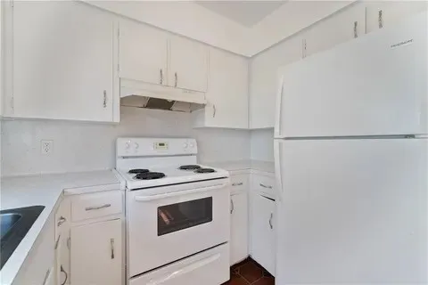 a kitchen with cabinets and white appliances