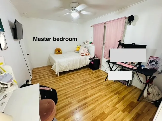 a bedroom with furniture and a wooden floor