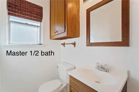 a bathroom with a sink a toilet and mirror