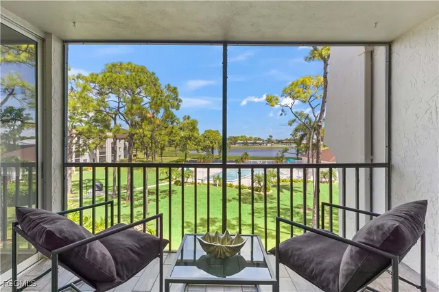 a living room filled with furniture and floor to ceiling window