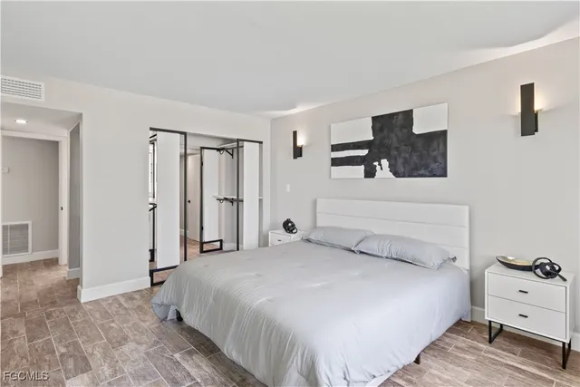 a bedroom with a large bed and a tv