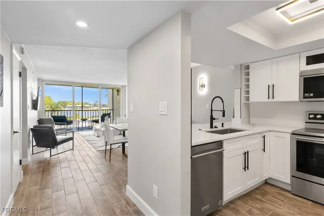 a kitchen with sink stove and cabinets