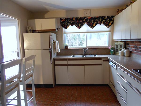 48 Meadowview Road Holyoke, MA 01040 - Photo 6 of 9 a kitchen with granite countertop a sink a window appliances and cabinets