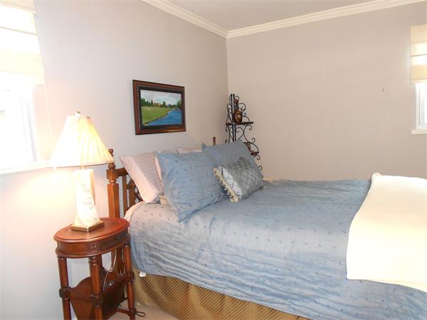 48 Meadowview Road Holyoke, MA 01040 - Photo 8 of 9 a bed sitting in a bedroom next to a window with a wooden floor