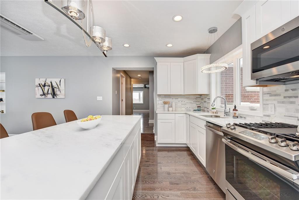 1242 Morrow Road Pittsburgh, PA 15241 - Photo 5 of 25 A five person island finished with a sleek white granite.