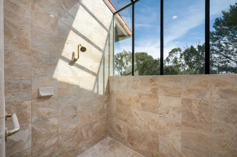 a view of a balcony with couch and chairs