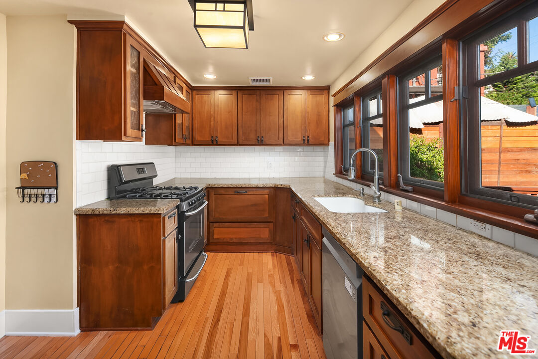 1436 Silver Boulevard Los Angeles, CA 90026 - Photo 11 of 31 a kitchen with granite countertop a sink stove and cabinets
