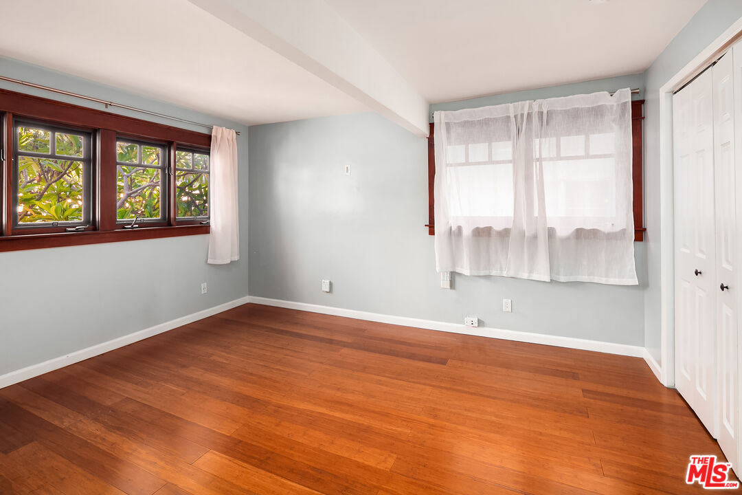 1436 Silver Boulevard Los Angeles, CA 90026 - Photo 13 of 31 a view of an empty room with wooden floor and a window