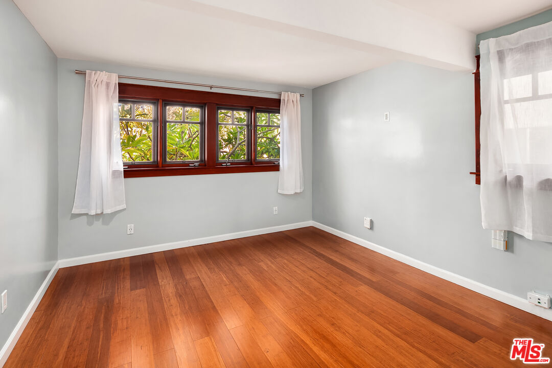 1436 Silver Boulevard Los Angeles, CA 90026 - Photo 14 of 31 an empty room with wooden floor and windows