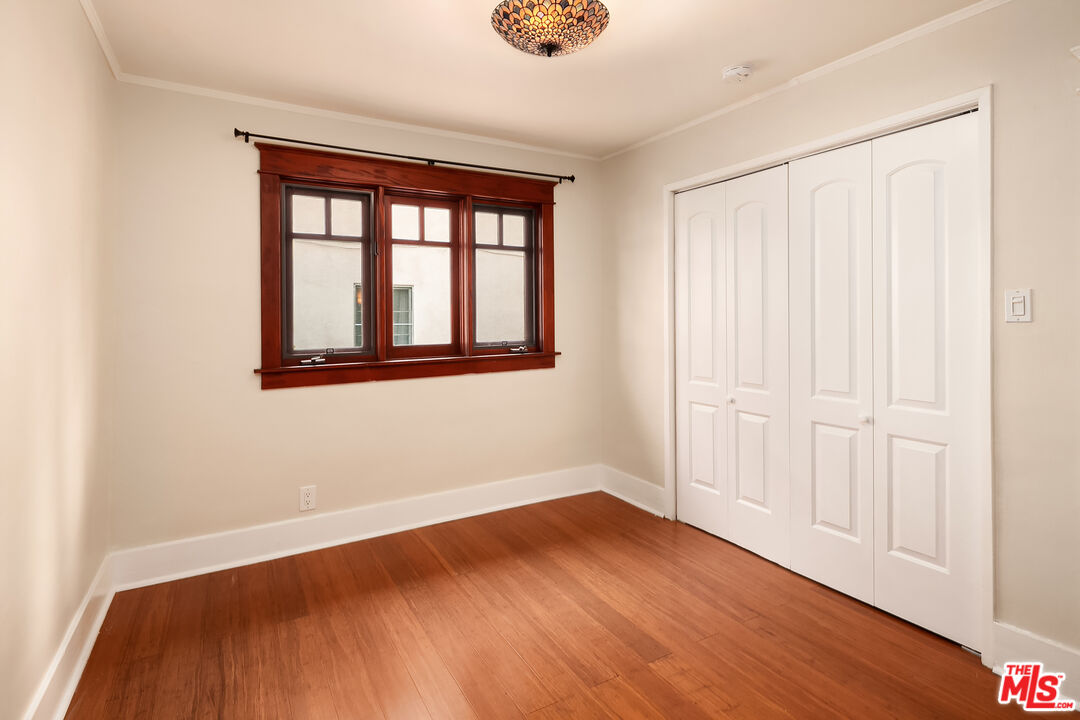 1436 Silver Boulevard Los Angeles, CA 90026 - Photo 17 of 31 an empty room with wooden floor and windows